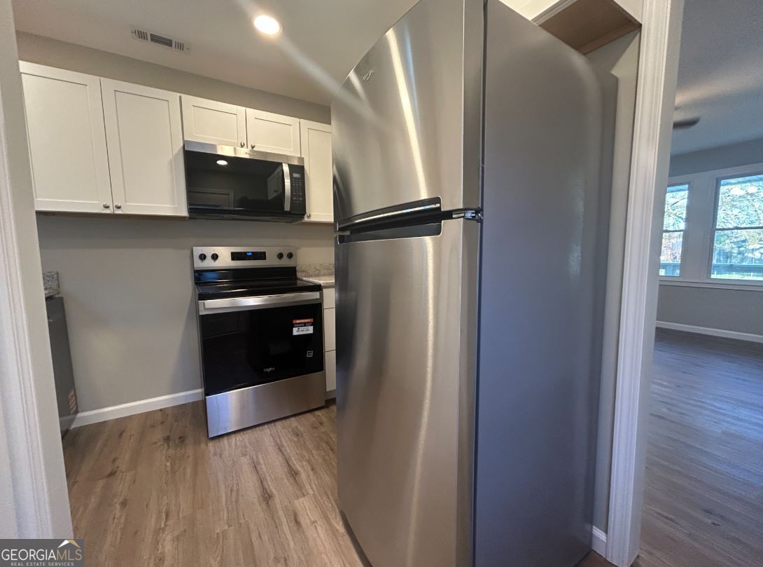 116 Holly Street Southeast Rome, GA 30161 - Photo 3 of 6 a kitchen with stainless steel appliances granite countertop a refrigerator and a stove top oven