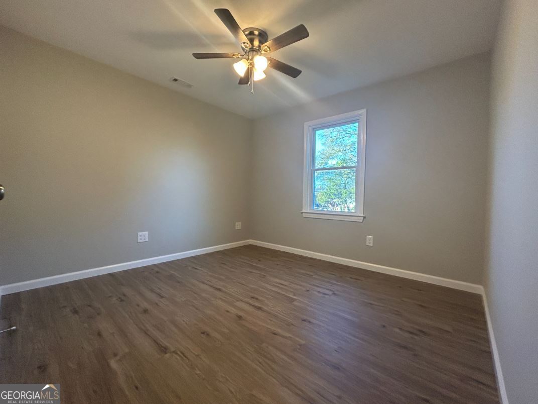 116 Holly Street Southeast Rome, GA 30161 - Photo 4 of 6 an empty room with wooden floor and windows