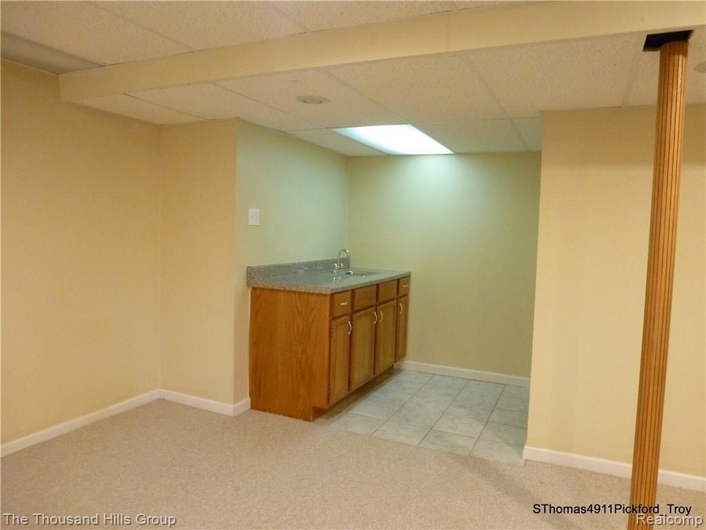 4911 Pickford Drive Troy, MI 48085 - Photo 44 of 46 BASEMENT WITH WET BAR.