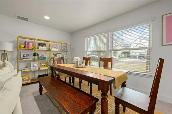 a view of a dining room with furniture window and outside view
