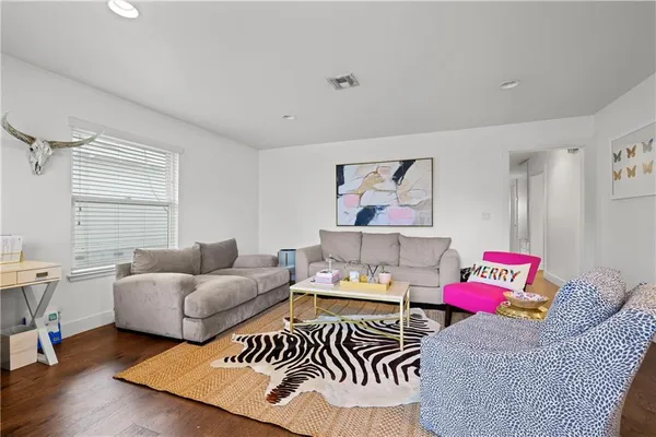 a view of a dining room with furniture and wooden floor