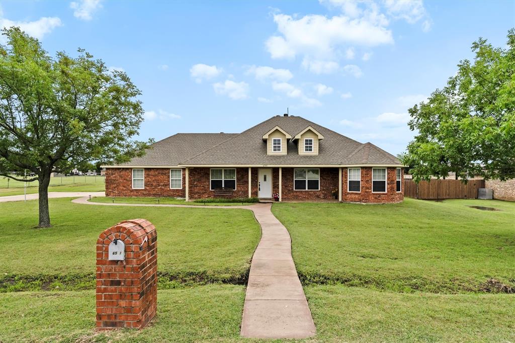 6581 Meadow Ridge Circle Nevada, TX 75173 - Photo 12 of 40 a front view of a house with garden