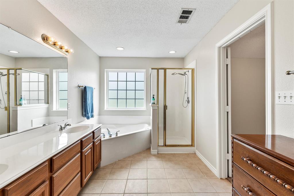 6581 Meadow Ridge Circle Nevada, TX 75173 - Photo 24 of 40 a large spacious bathroom with a large tub shower and sink