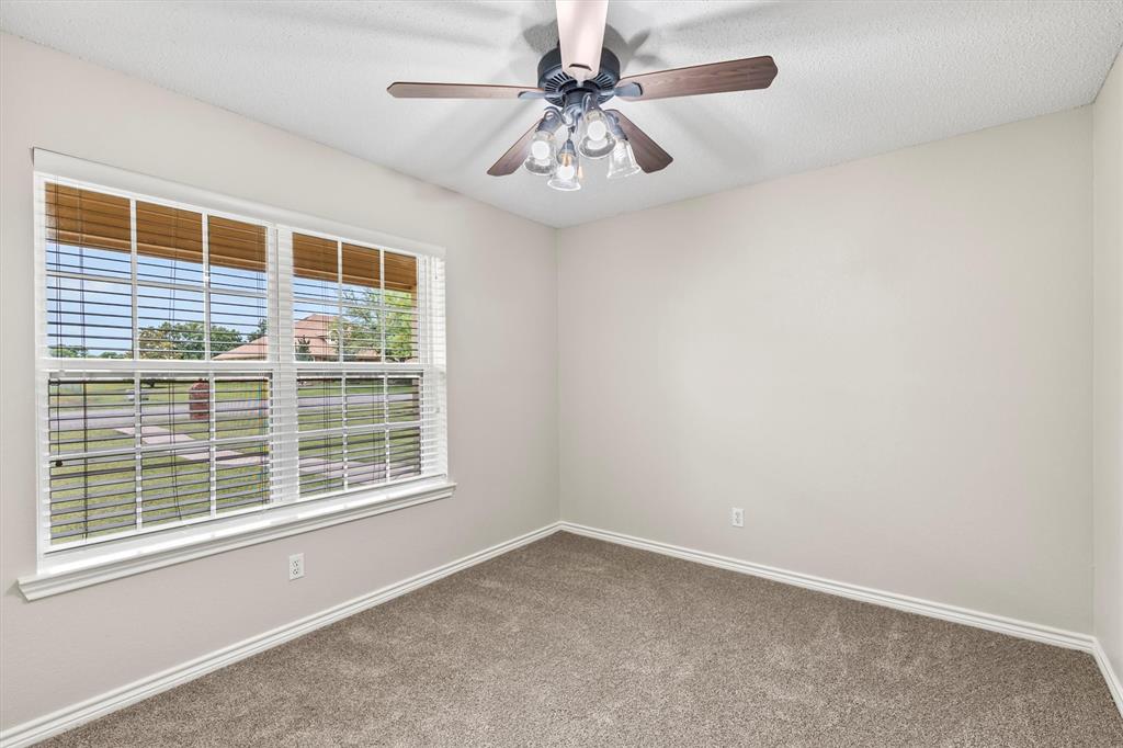 6581 Meadow Ridge Circle Nevada, TX 75173 - Photo 26 of 40 an empty room with a window and a ceiling fan