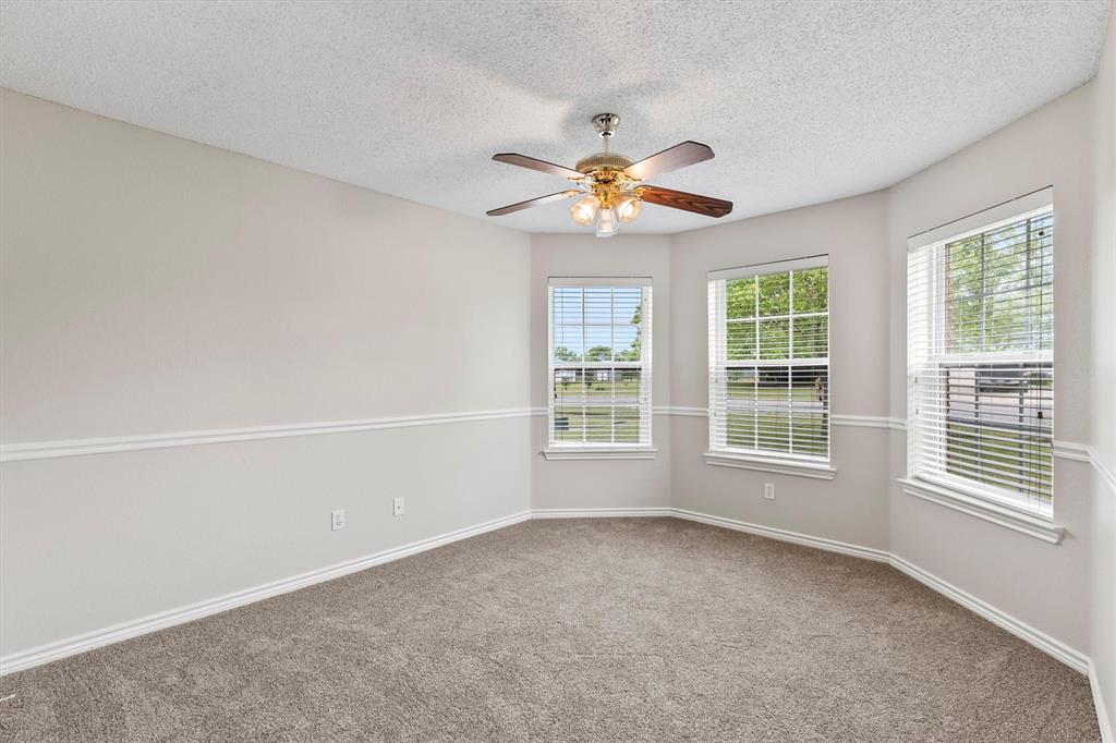 6581 Meadow Ridge Circle Nevada, TX 75173 - Photo 28 of 40 an empty room with a window and a ceiling fan