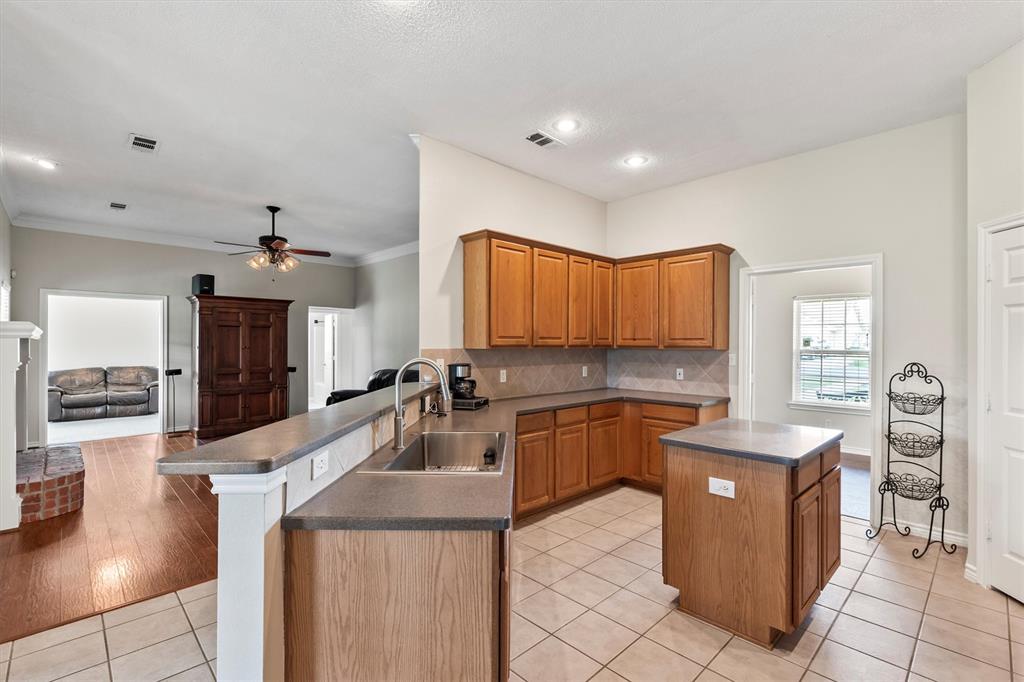 6581 Meadow Ridge Circle Nevada, TX 75173 - Photo 36 of 40 a kitchen with a sink a counter top space appliances and cabinets