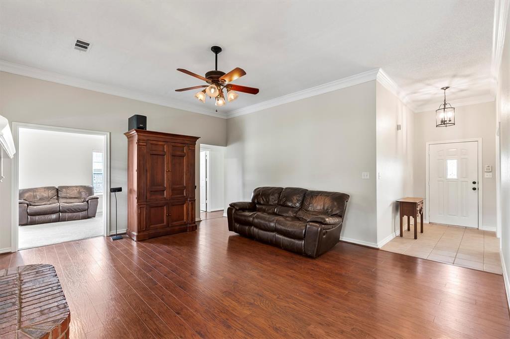 6581 Meadow Ridge Circle Nevada, TX 75173 - Photo 39 of 40 a living room with furniture and a wooden floor