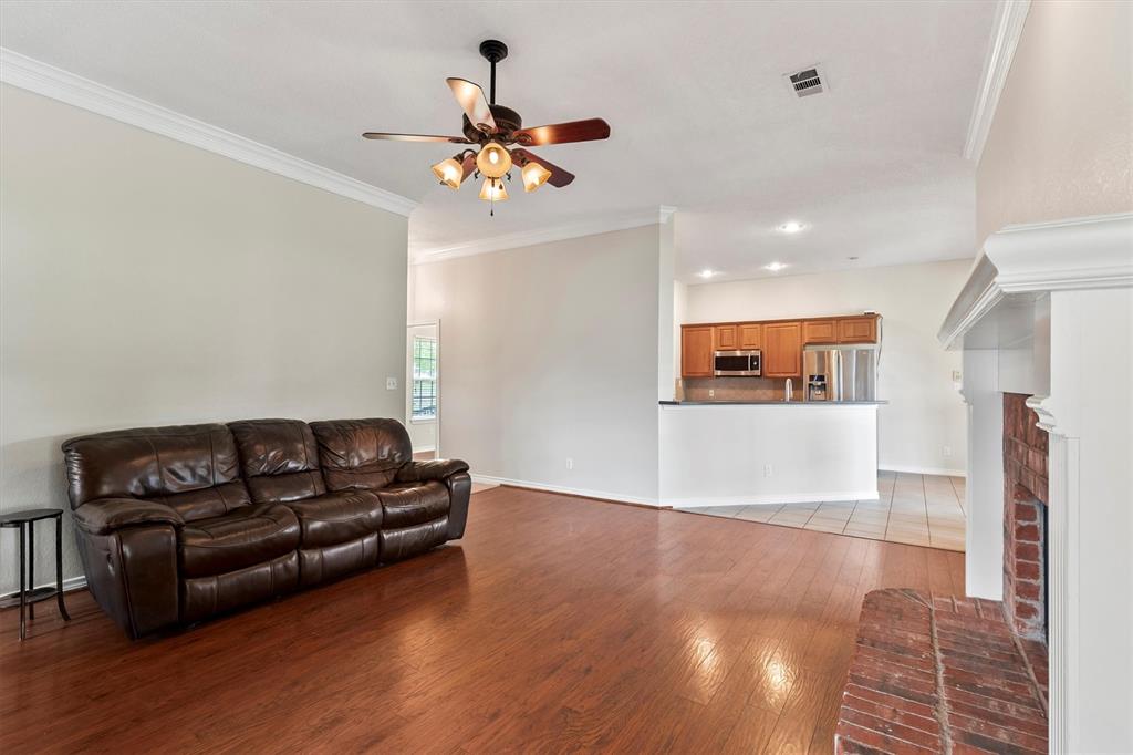 6581 Meadow Ridge Circle Nevada, TX 75173 - Photo 7 of 40 a living room with furniture and a wooden floor