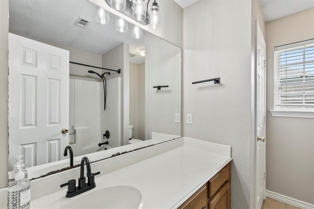6581 Meadow Ridge Circle Nevada, TX 75173 - Photo 9 of 40 a bathroom with a sink and a mirror