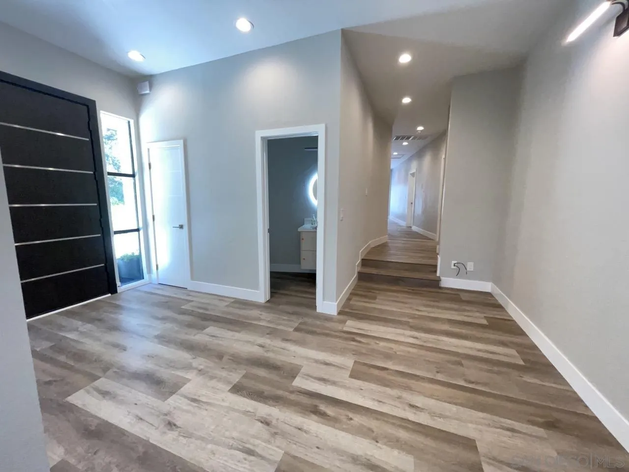 6611 Lago Corte Rancho Santa Fe, CA 92091 - Photo 11 of 38 a view of a hallway view with staircase and a window