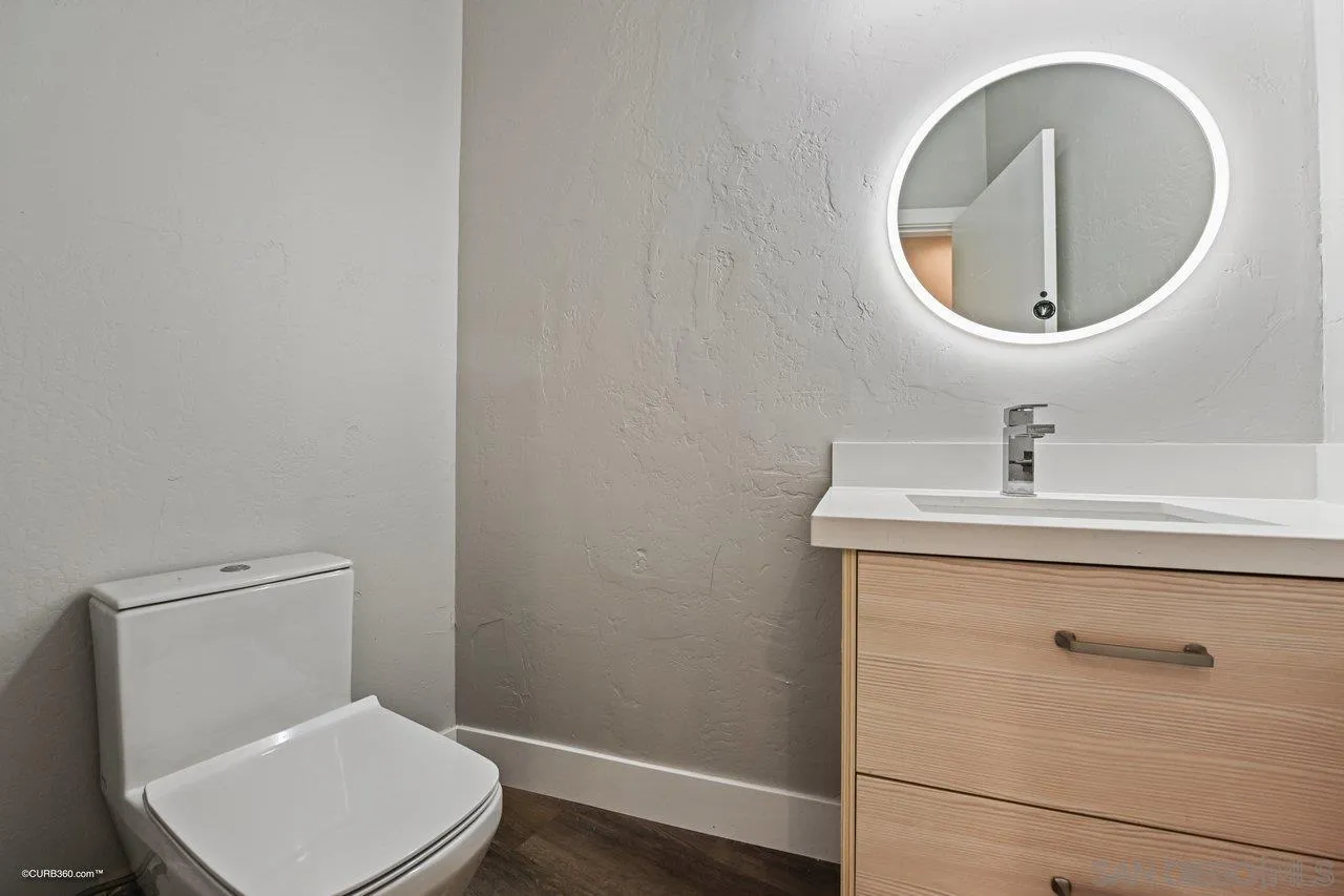 6611 Lago Corte Rancho Santa Fe, CA 92091 - Photo 12 of 38 a bathroom with a toilet sink and mirror