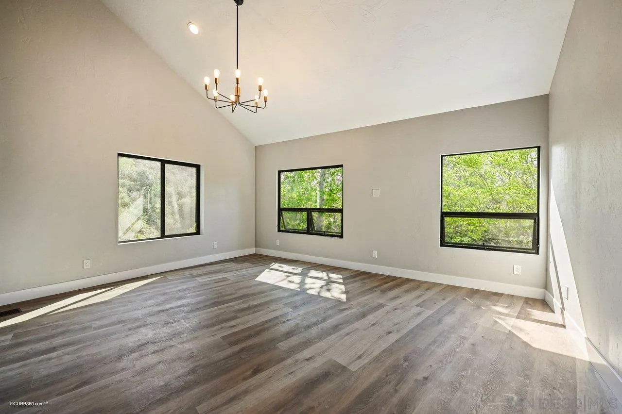 6611 Lago Corte Rancho Santa Fe, CA 92091 - Photo 14 of 38 a view of an empty room with wooden floor and a window