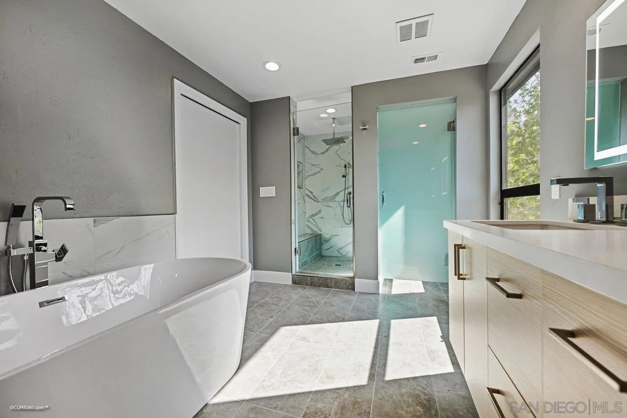 6611 Lago Corte Rancho Santa Fe, CA 92091 - Photo 18 of 38 a bathroom with a tub sink and mirror