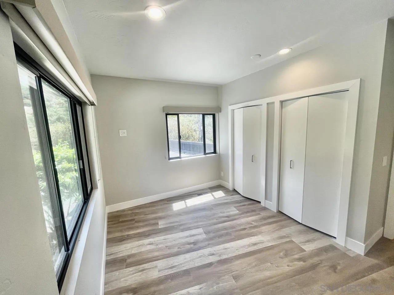 6611 Lago Corte Rancho Santa Fe, CA 92091 - Photo 19 of 38 a view of an empty room with wooden floor and a window