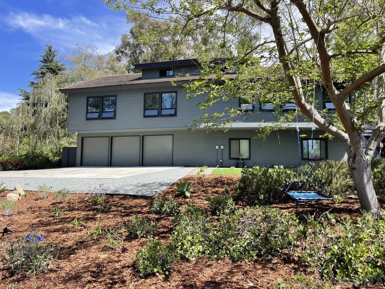 6611 Lago Corte Rancho Santa Fe, CA 92091 - Photo 2 of 38 a front view of a house with a yard and garage