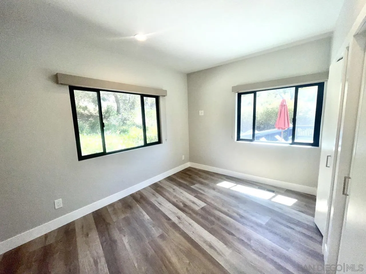 6611 Lago Corte Rancho Santa Fe, CA 92091 - Photo 21 of 38 a view of an empty room with wooden floor and a window