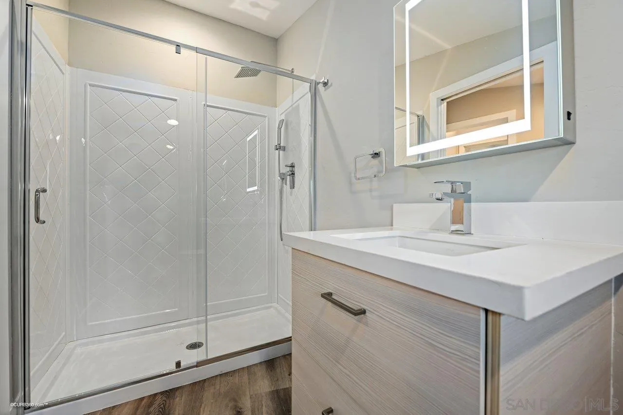 6611 Lago Corte Rancho Santa Fe, CA 92091 - Photo 25 of 38 a bathroom with a shower sink and mirror