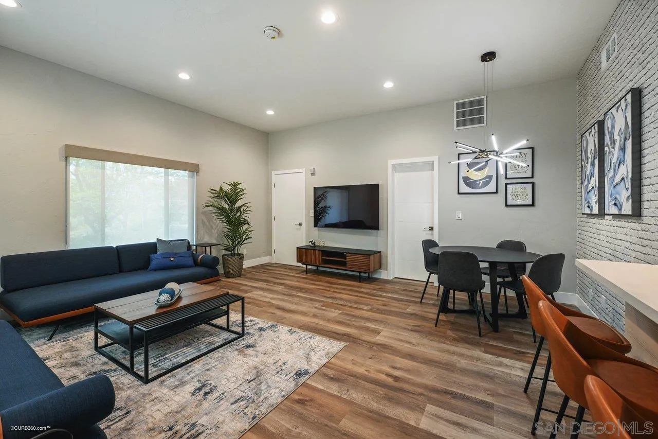 6611 Lago Corte Rancho Santa Fe, CA 92091 - Photo 29 of 38 a living room with furniture a wooden floor and a flat screen tv