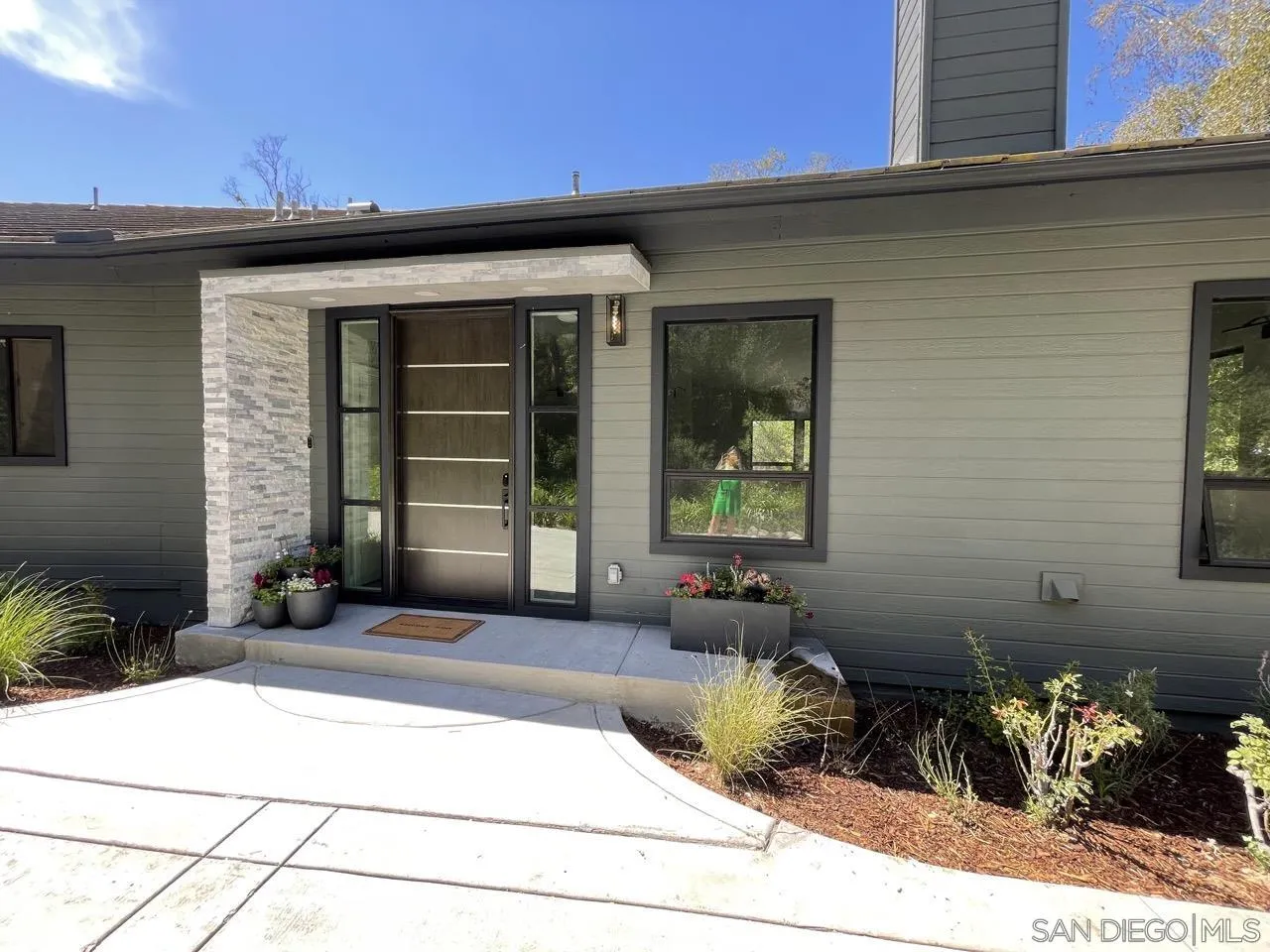 6611 Lago Corte Rancho Santa Fe, CA 92091 - Photo 3 of 38 a front view of a house with potted plants