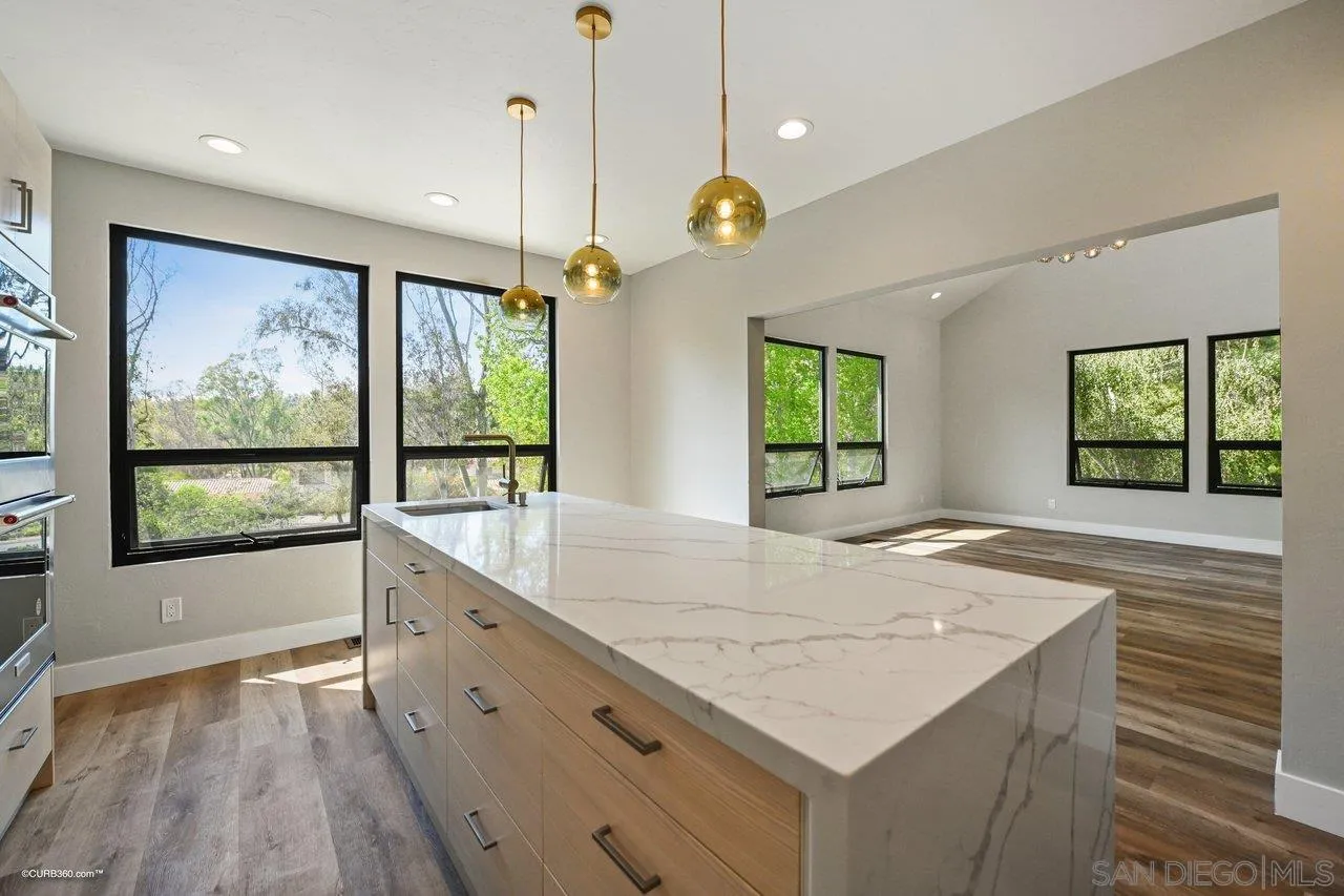 6611 Lago Corte Rancho Santa Fe, CA 92091 - Photo 6 of 38 a open kitchen with a refrigerator a sink and wooden floor