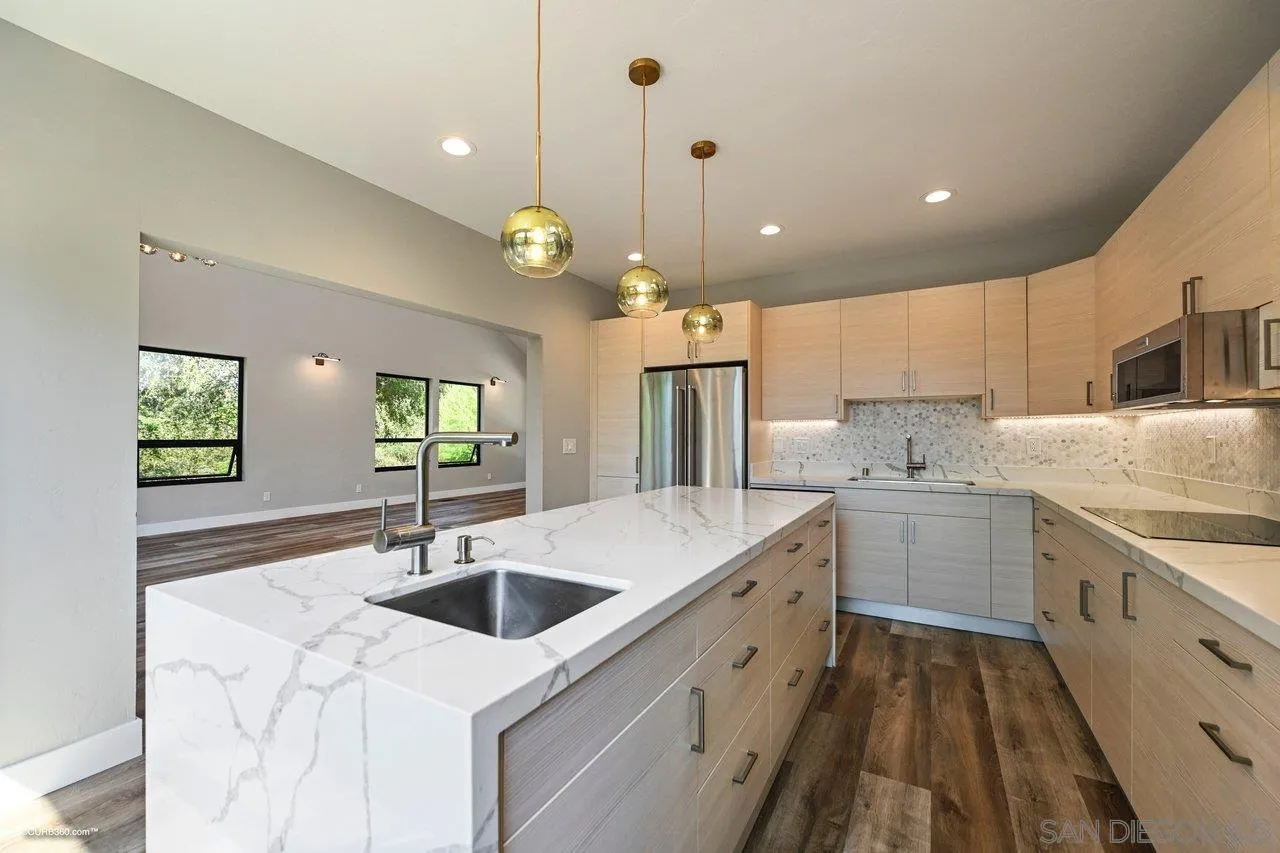 6611 Lago Corte Rancho Santa Fe, CA 92091 - Photo 7 of 38 a kitchen with a sink stove and wooden floor