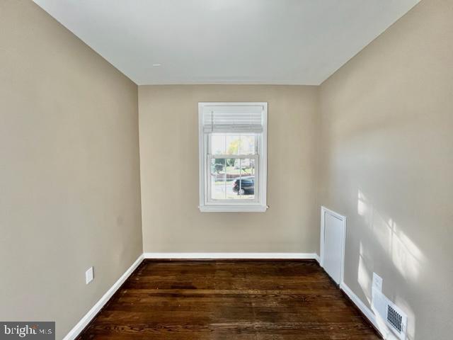 5128 Mangum Road College Park, MD 20740 - Photo 16 of 40 a view of an empty room with wooden floor and a window