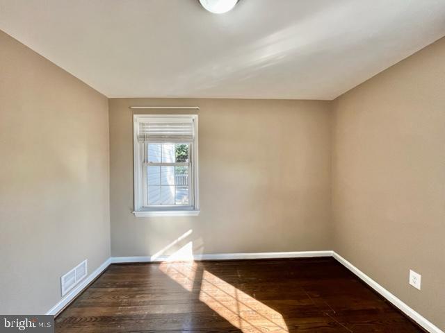 5128 Mangum Road College Park, MD 20740 - Photo 19 of 40 an empty room with wooden floor and windows