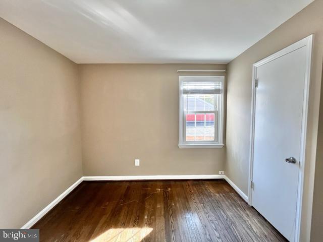 5128 Mangum Road College Park, MD 20740 - Photo 20 of 40 a view of an empty room with wooden floor and a window