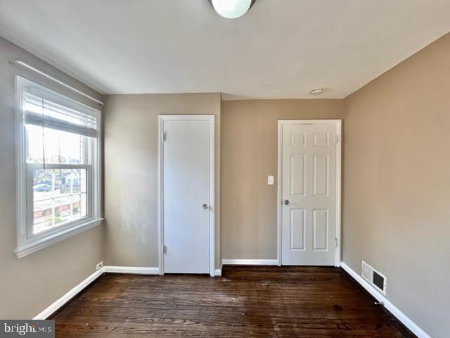 5128 Mangum Road College Park, MD 20740 - Photo 21 of 40 a view of an empty room with wooden floor and a window