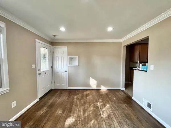 a view of empty room with wooden floor
