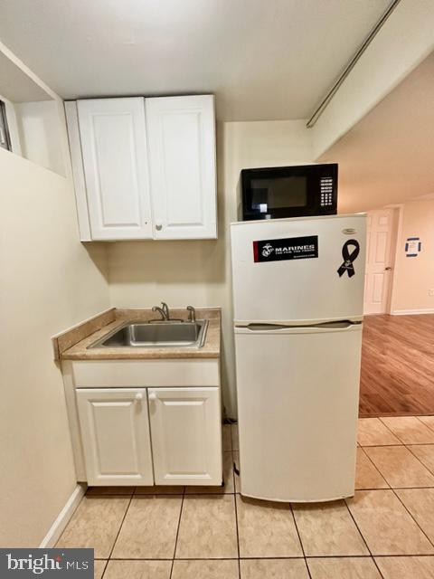 5128 Mangum Road College Park, MD 20740 - Photo 40 of 40 a white refrigerator freezer sitting inside of a kitchen