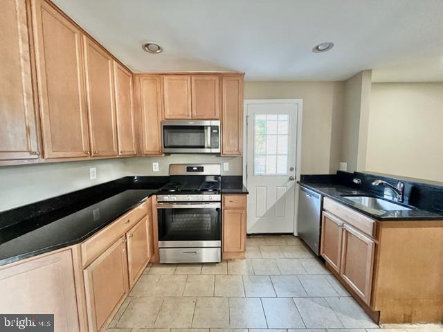 5128 Mangum Road College Park, MD 20740 - Photo 5 of 40 a kitchen with stainless steel appliances granite countertop a sink and a stove