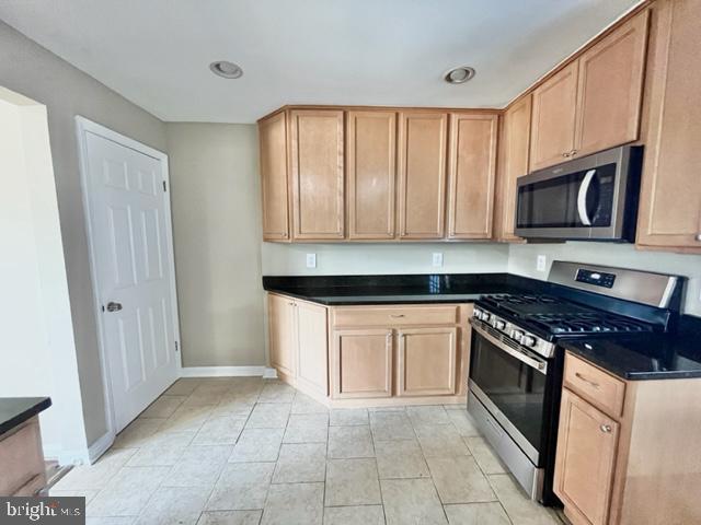 5128 Mangum Road College Park, MD 20740 - Photo 7 of 40 a kitchen with granite countertop a stove top oven microwave and cabinets