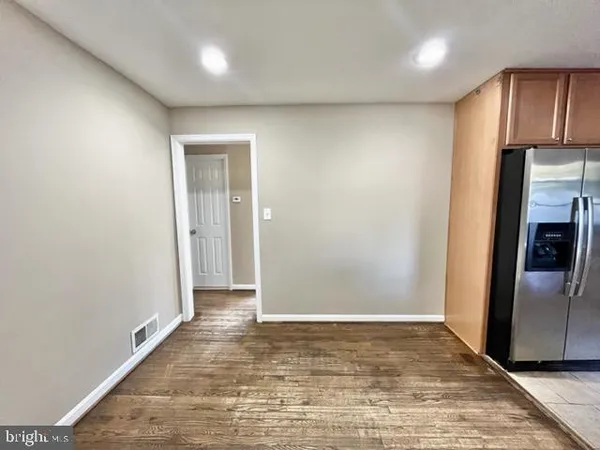 a view of a refrigerator in kitchen and wooden floor