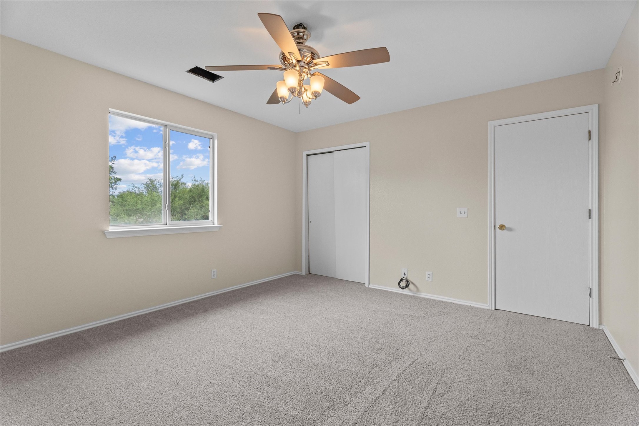172 Discovery Kyle, TX 78640 - Photo 6 of 21 Spacious primary bedroom featuring plush carpeting, ceiling fan for added , and closet storage.