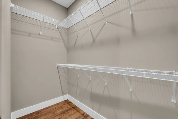 a view of a room with wooden floor
