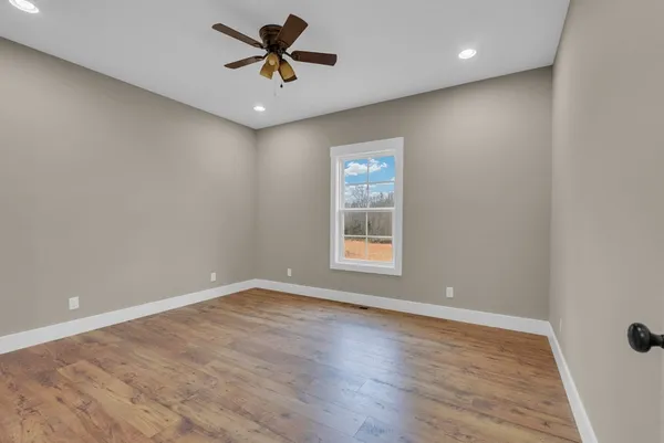 wooden floor in an empty room with a window