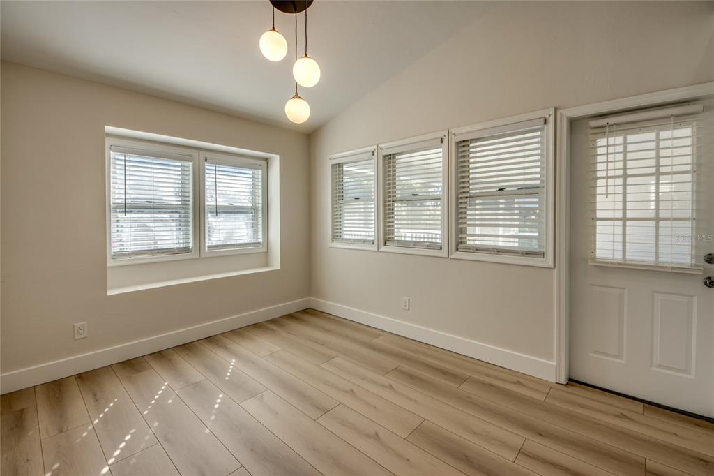 6205 Deer Run Fort Myers, FL 33908 - Photo 21 of 52 a view of an empty room with wooden floor and a window