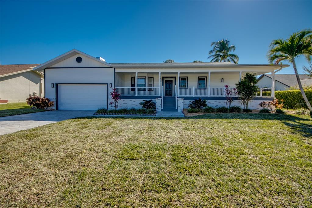 6205 Deer Run Fort Myers, FL 33908 - Photo 3 of 52 a front view of a house with a yard and garage