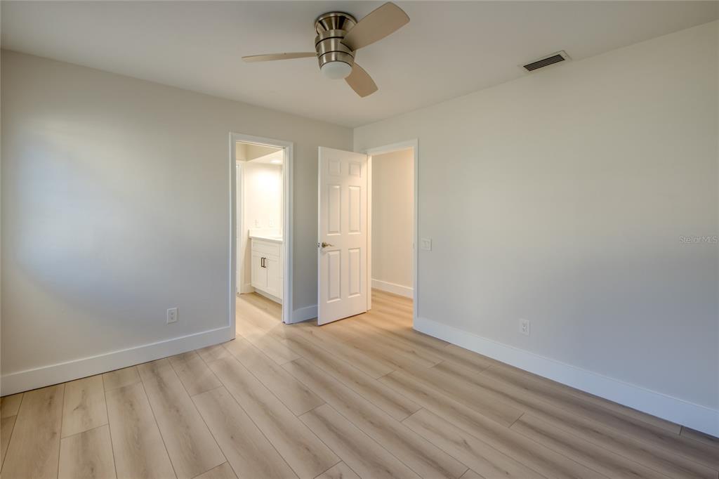 6205 Deer Run Fort Myers, FL 33908 - Photo 32 of 52 a view of an empty room with wooden floor and a window