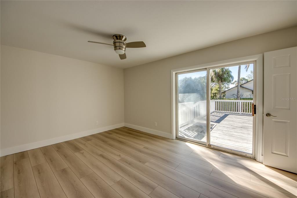 6205 Deer Run Fort Myers, FL 33908 - Photo 40 of 52 an empty room with wooden floor and windows