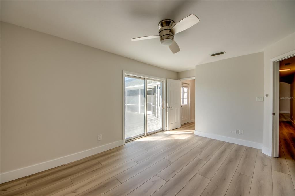 6205 Deer Run Fort Myers, FL 33908 - Photo 41 of 52 a view of empty room with wooden floor and fan