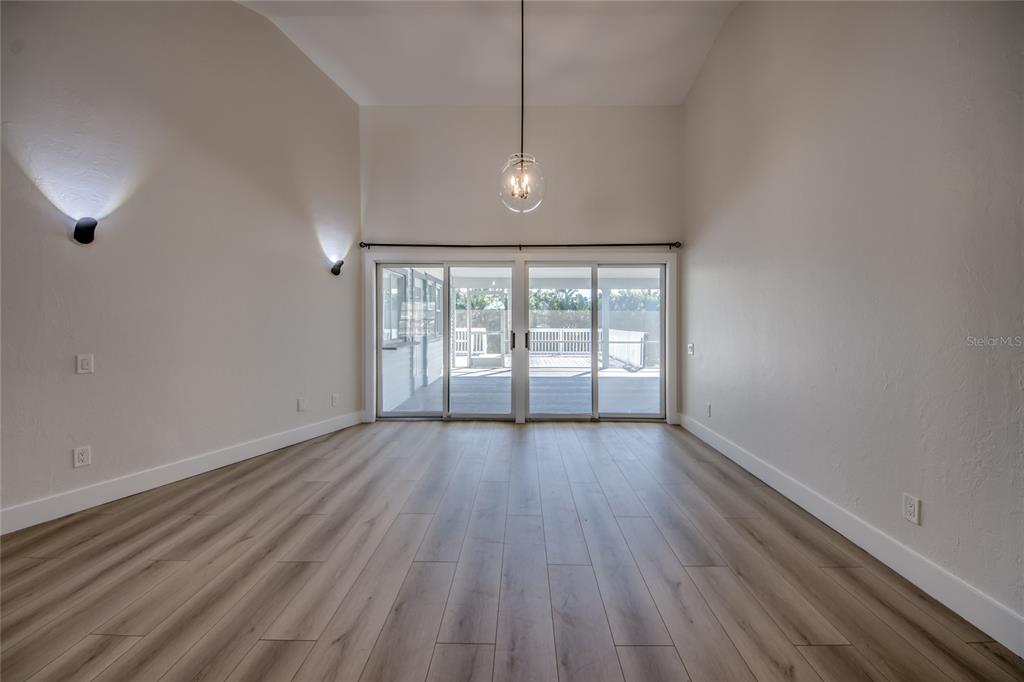 6205 Deer Run Fort Myers, FL 33908 - Photo 7 of 52 an empty room with wooden floor and windows