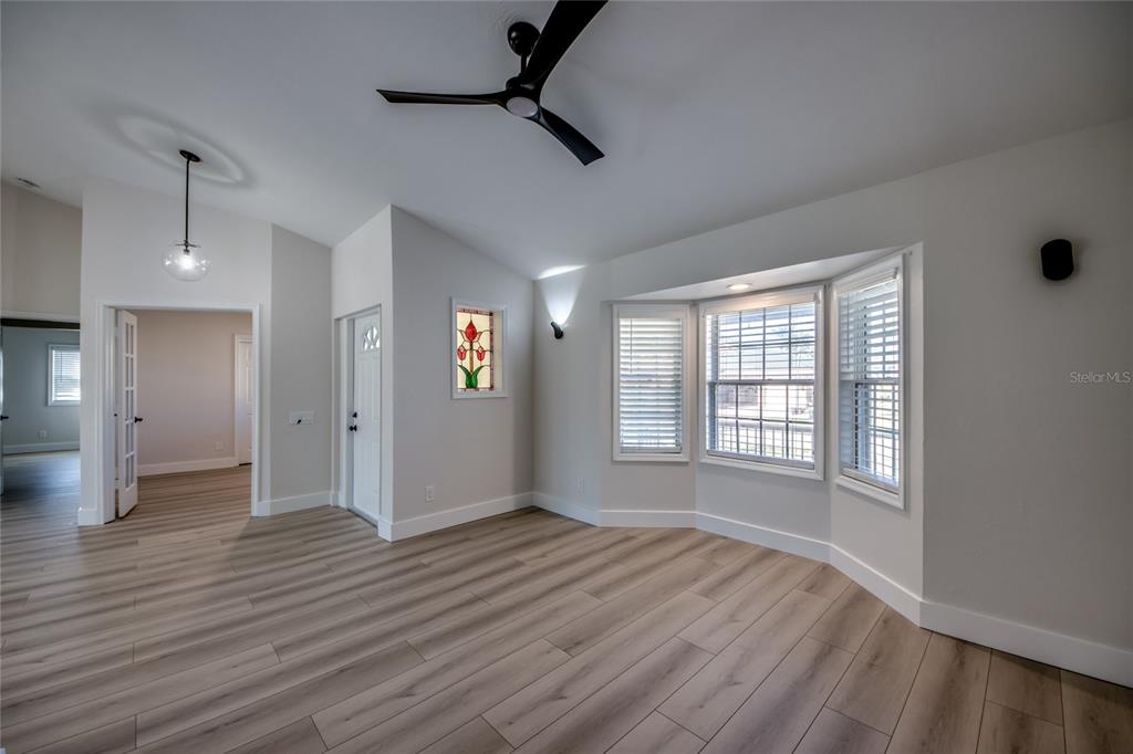 6205 Deer Run Fort Myers, FL 33908 - Photo 10 of 52 a view of an empty room with wooden floor and a window
