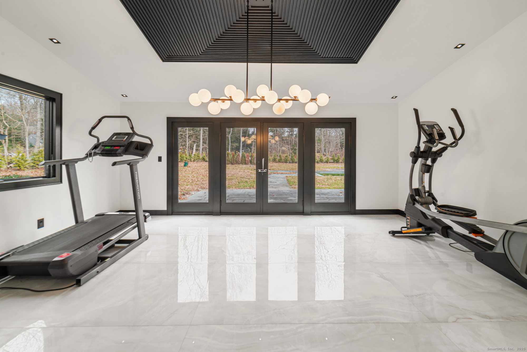 113 Woodbrook Drive Stamford, CT 06907 - Photo 11 of 39 a room with gym equipment and large mirror