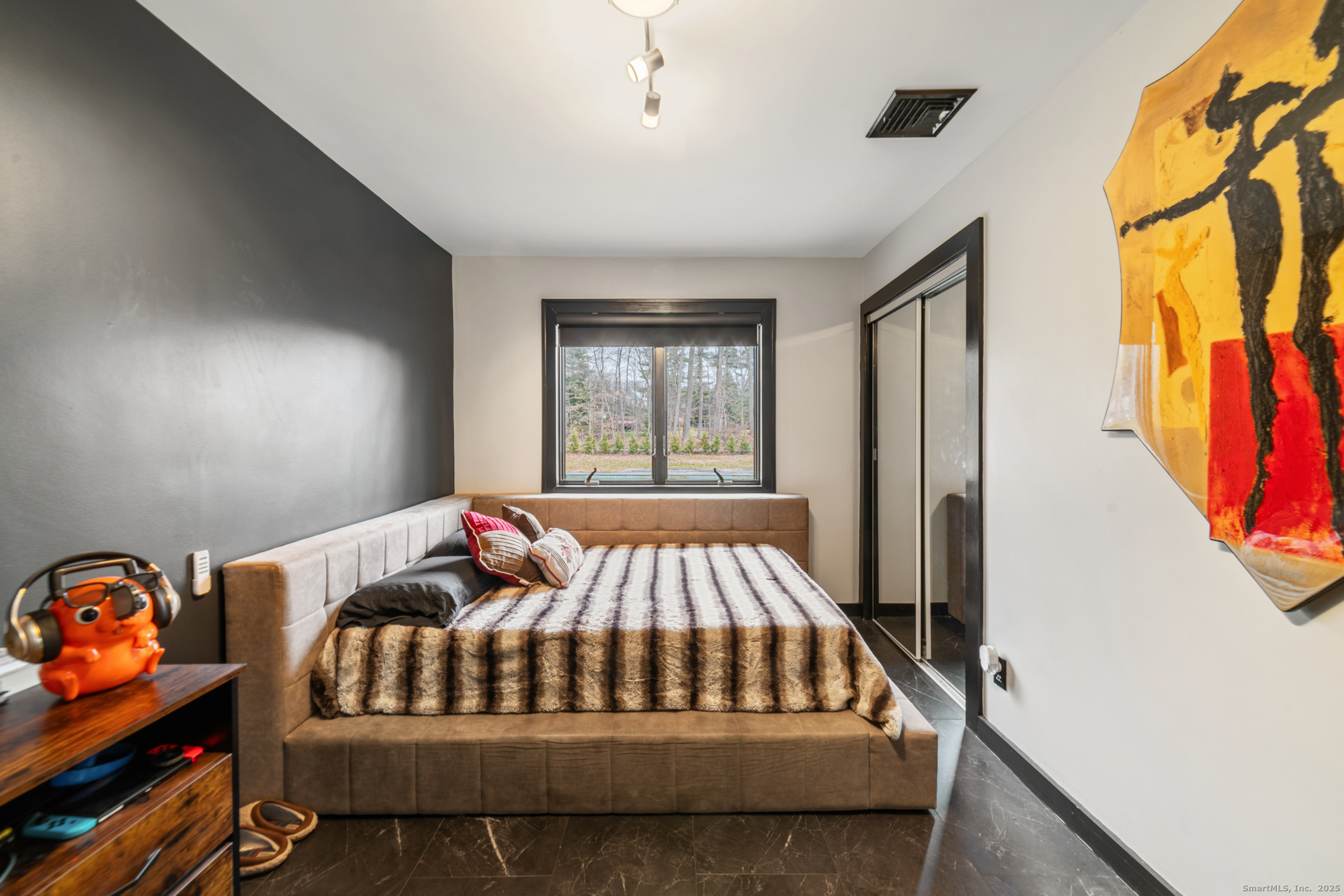 113 Woodbrook Drive Stamford, CT 06907 - Photo 19 of 39 a bedroom with a bed and wooden floor