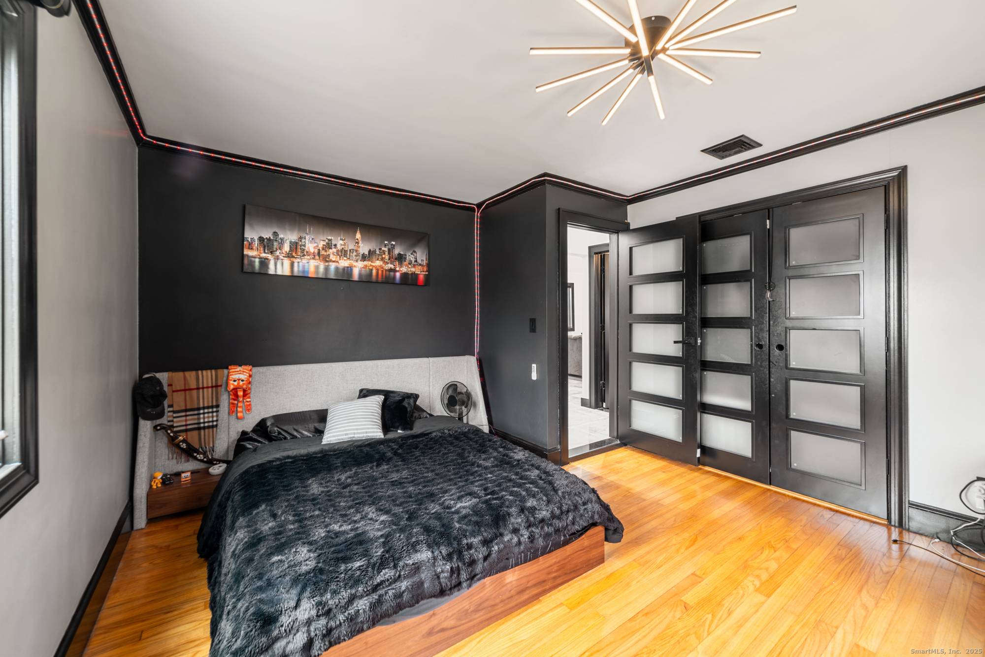 113 Woodbrook Drive Stamford, CT 06907 - Photo 21 of 39 a bedroom with a bed and a chandelier