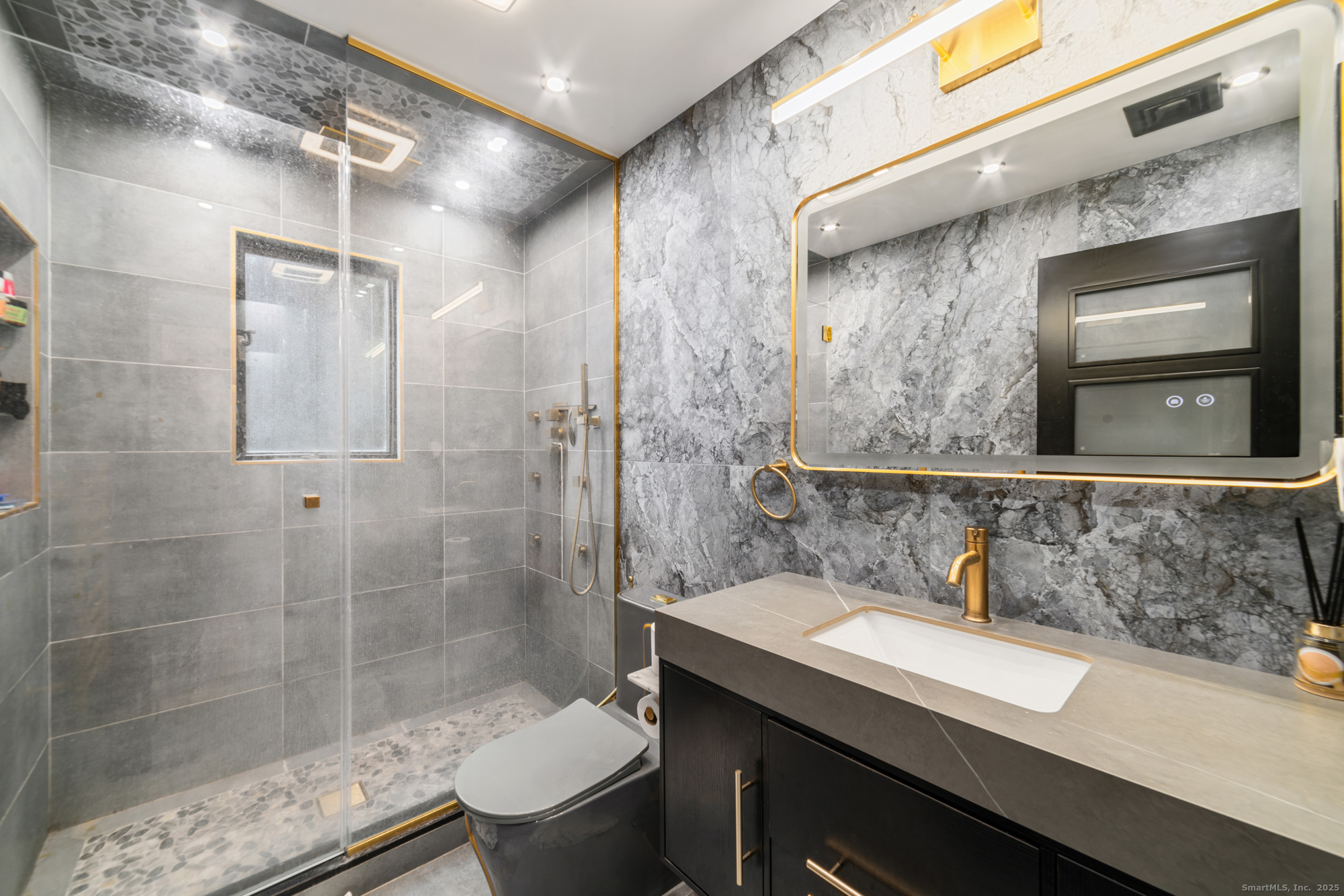 113 Woodbrook Drive Stamford, CT 06907 - Photo 22 of 39 a bathroom with a sink a toilet and shower