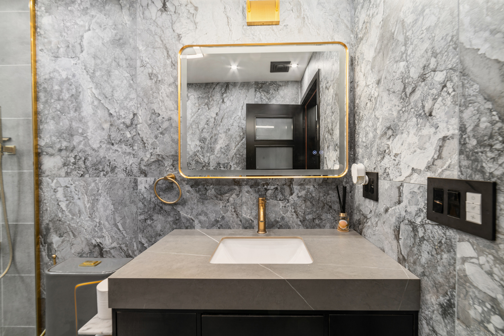 113 Woodbrook Drive Stamford, CT 06907 - Photo 23 of 39 a bathroom with a sink and a mirror