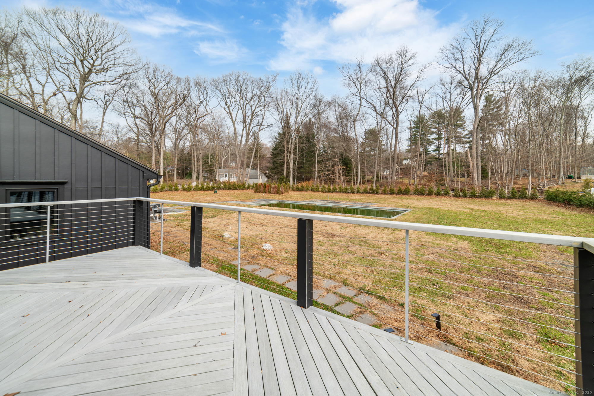 113 Woodbrook Drive Stamford, CT 06907 - Photo 34 of 39 a view of a balcony with wooden floor and fence